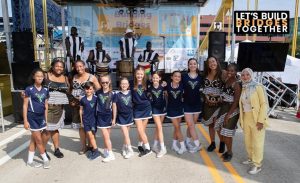 An Irish band and African band pose for a photo during Building Bridges Day on August 23 with founder Ebtehal Bawadi (right).
